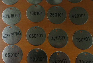 deep engraved text on valve identification tag 